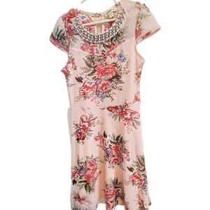 Girl's Monteau dress. Size 8 blush/pink with flowers. The neckline of the dress